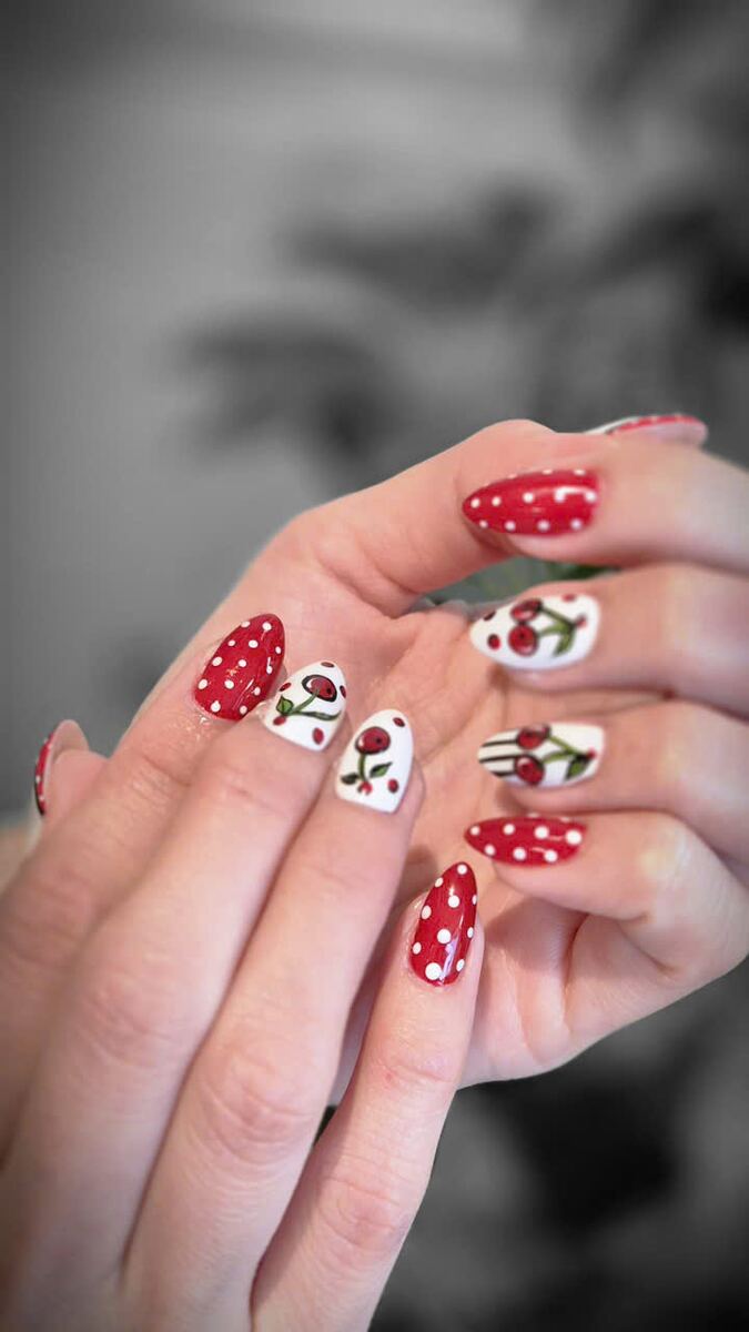 Red polka-dot and cherry nail art