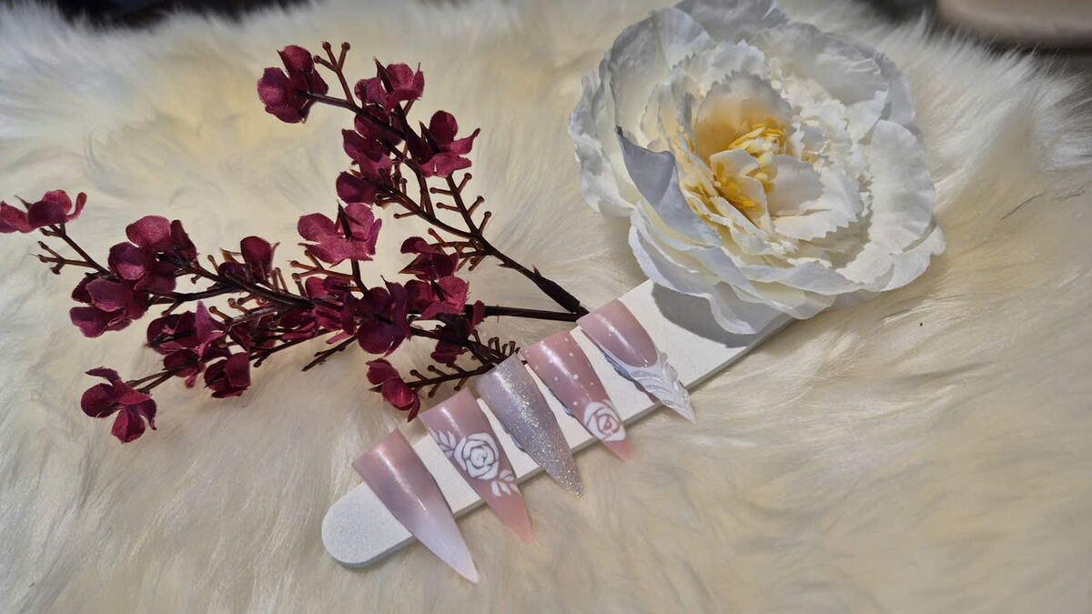 Hand-finished nail tips displayed with flowers