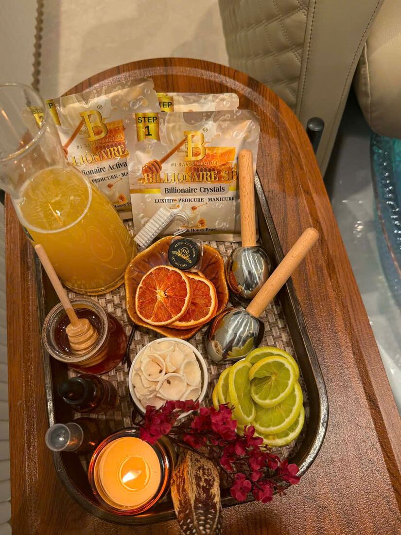 Spa pedicure tray with citrus slices, fresh juice, candle and herbal scrubs